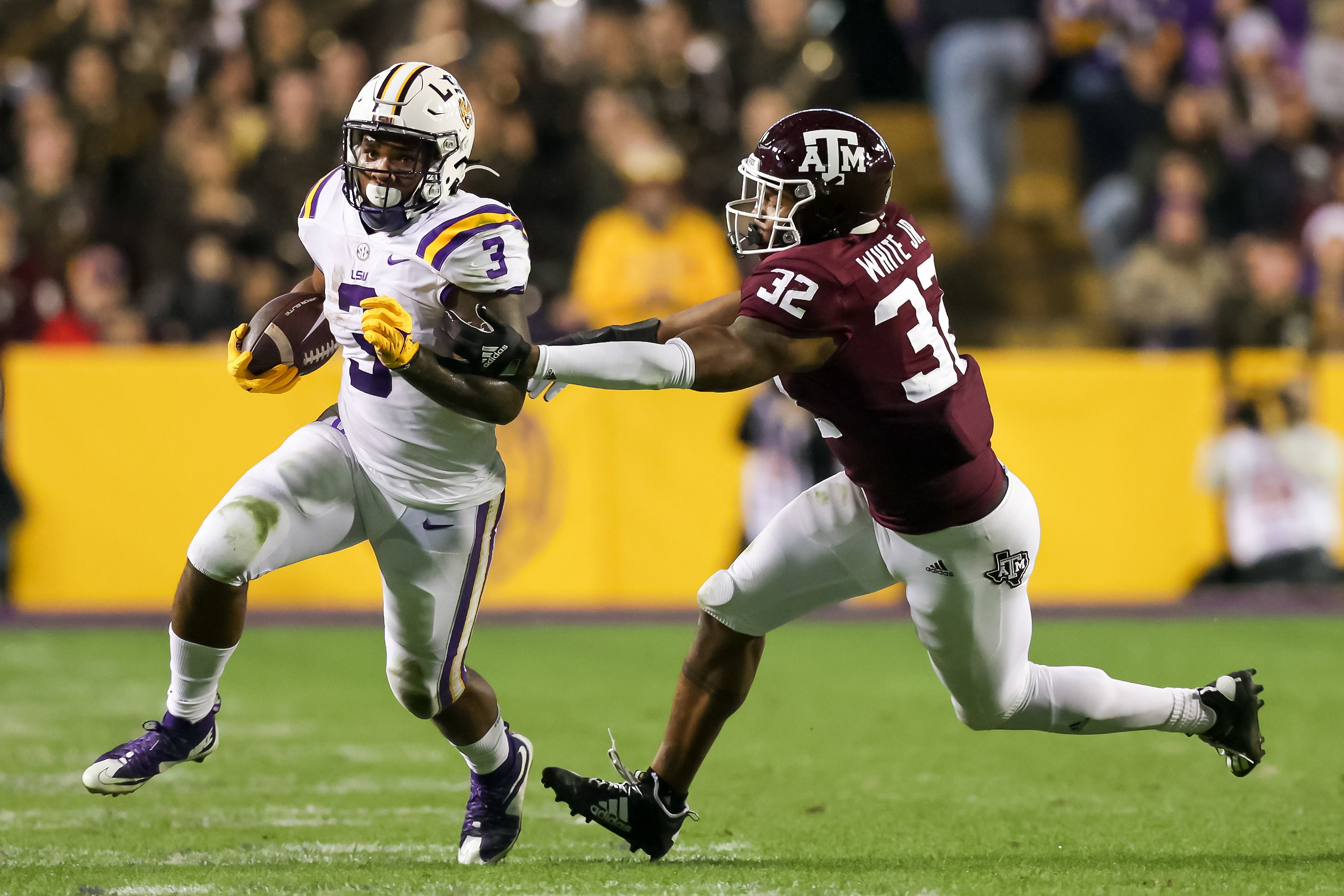 Nov 27, 2021; Baton Rouge, Louisiana, USA; LSU Tigers running back Tyrion Davis-Price (3) runs the ball against Texas A&M Aggies linebacker Andre White Jr. (32) during the first half at Tiger Stadium. Mandatory Credit: Stephen Lew-USA TODAY Sports