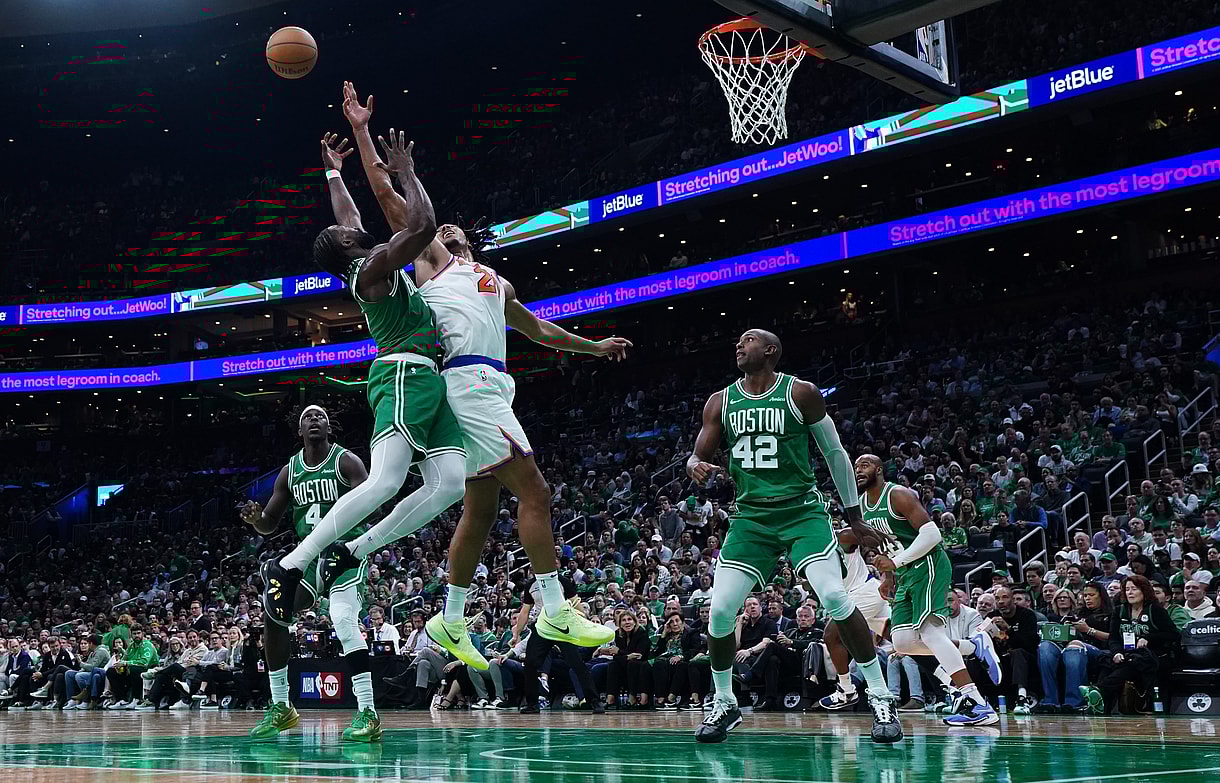 Oct 22, 2024; Boston, Massachusetts, USA; New York Knicks center Jericho Sims (20) and Boston Celtics guard Jaylen Brown (7) work for the ball in the second half at TD Garden. Mandatory Credit: David Butler II-Imagn Images