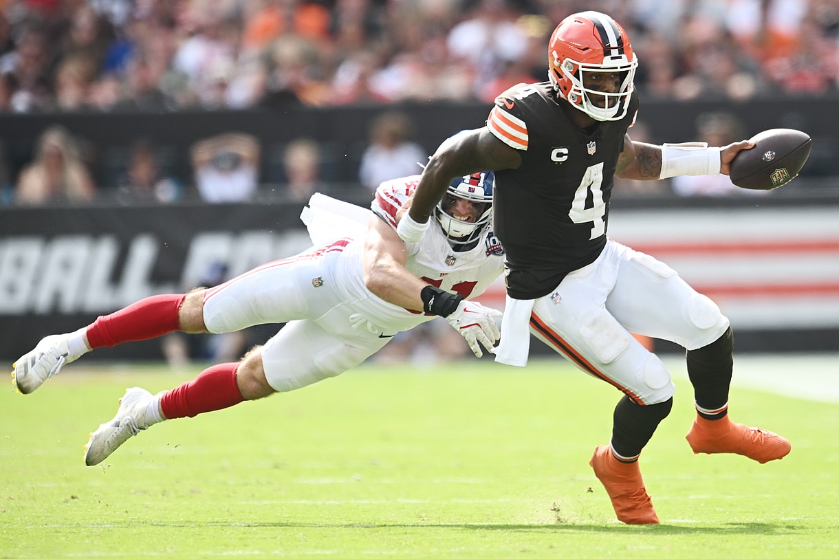 Sep 22, 2024; Cleveland, Ohio, USA; Cleveland Browns quarterback Deshaun Watson (4) scrambles from New York Giants linebacker Micah McFadden (41) during the second half at Huntington Bank Field. Mandatory Credit: Ken Blaze-Imagn Images