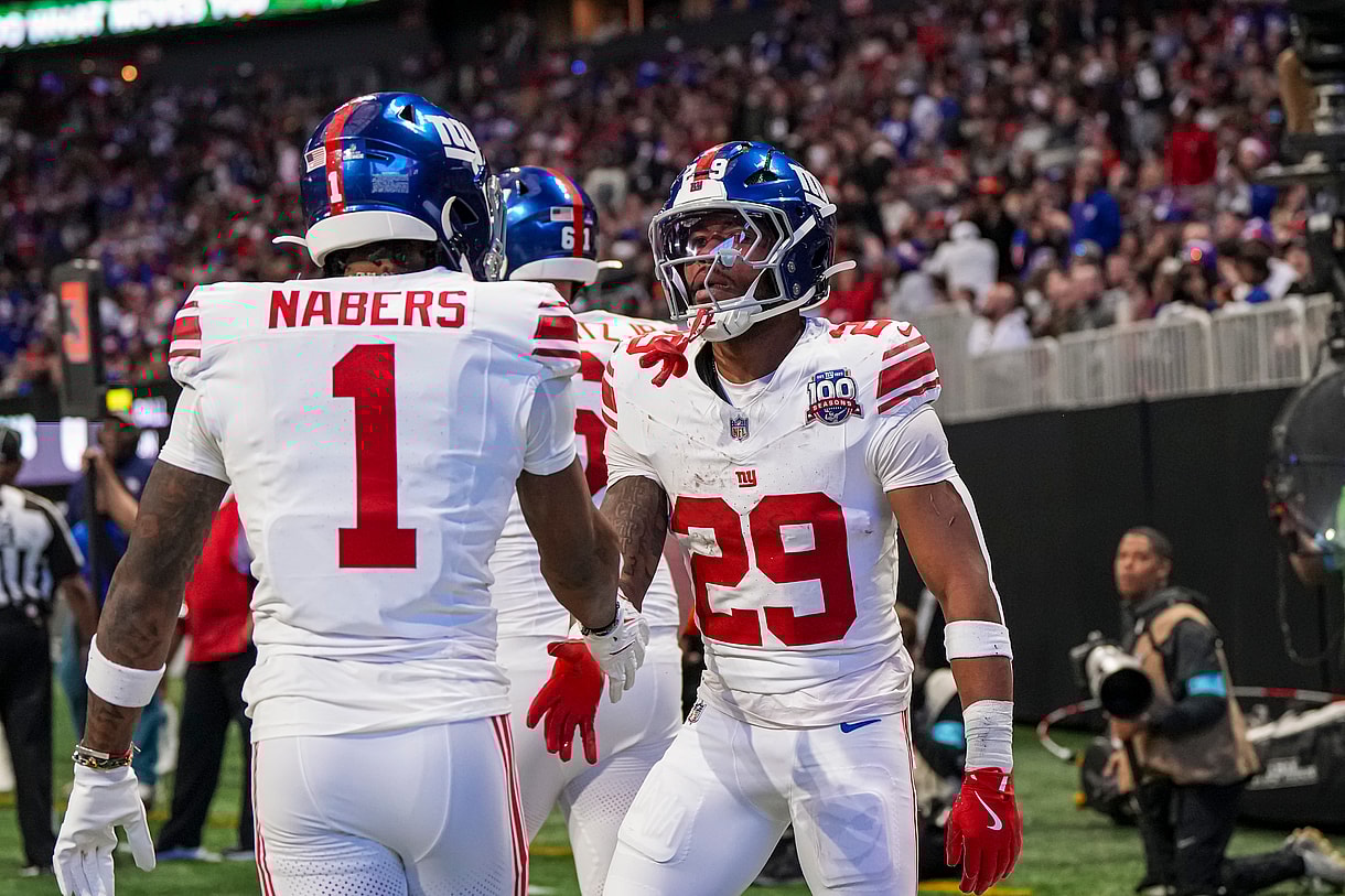 Dec 22, 2024; Atlanta, Georgia, USA; New York Giants running back Tyrone Tracy Jr. (29) reacts with wide receiver Malik Nabers (1) after catching a touchdown pass against the Atlanta Falcons during the first half at Mercedes-Benz Stadium. Mandatory Credit: Dale Zanine-Imagn Images