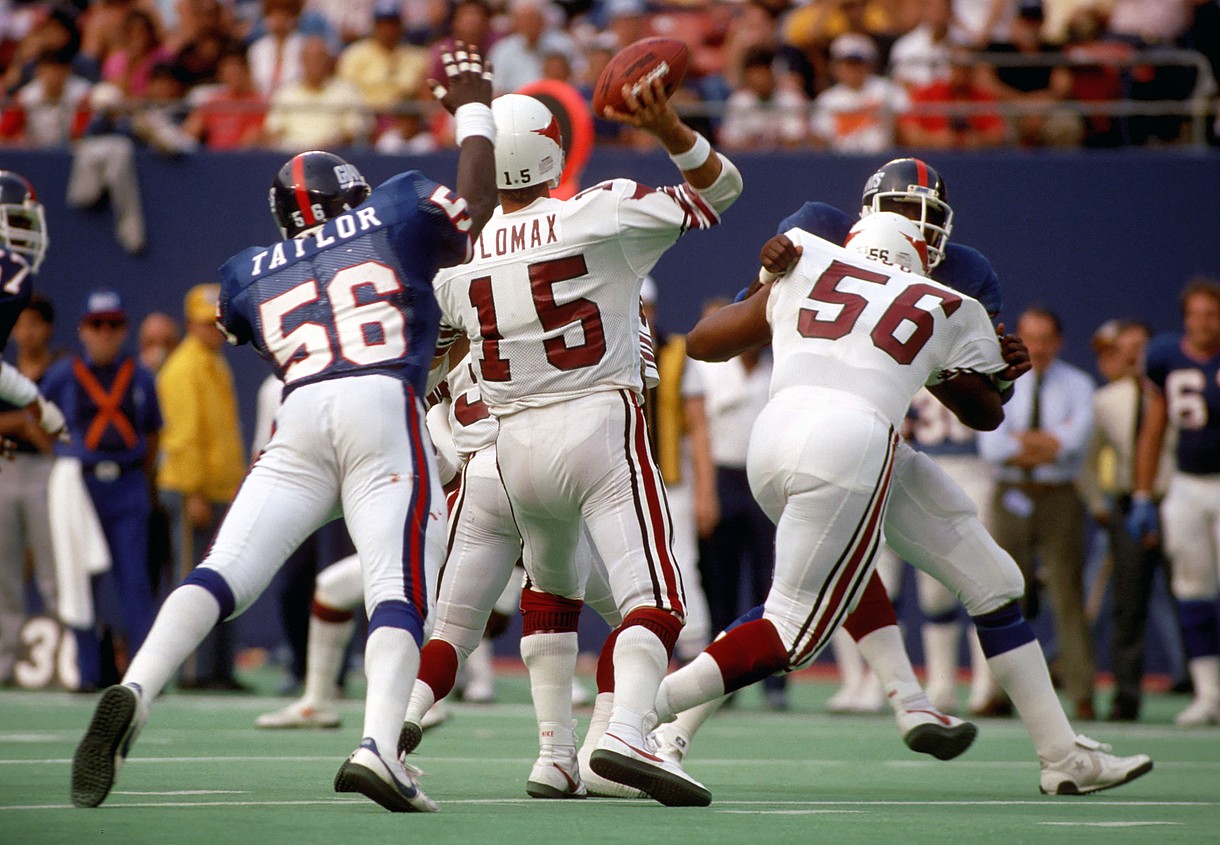 Sep 22, 1985; E. Rutherford, NJ, USA; FILE PHOTO; New York Giants Linebacker (56) LAWRENCE TAYLOR pressures St. Louis Cardinals quarterback (15) NEIL LOMAX at Giants Stadium. The Giants defeated the Cardinals 27-17. Mandatory Credit: Tony Tomsic-USA TODAY NETWORK