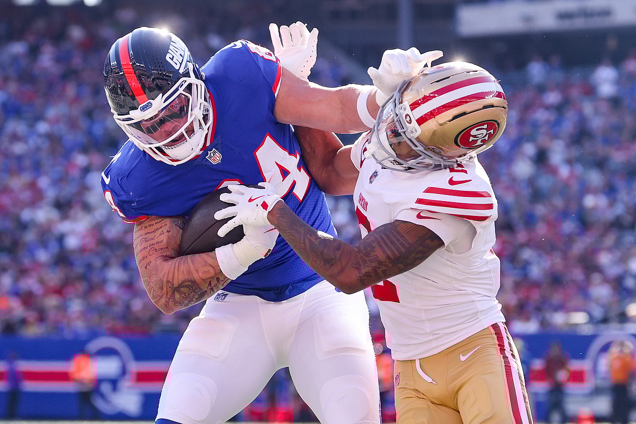Nov 2, 2025; East Rutherford, New Jersey, USA; New York Giants tight end Theo Johnson (84) runs after the catch for a touchdown as San Francisco 49ers cornerback Deommodore Lenoir (2) defends during the first half at MetLife Stadium. Mandatory Credit: Ed Mulholland-Imagn Images