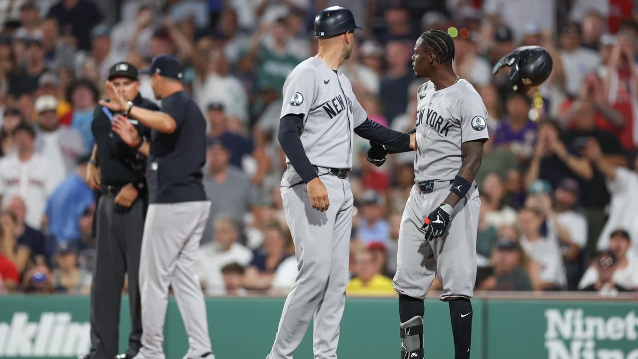 Jazz Chisholm Jr. being held back during a Yankees argument