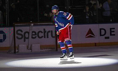 New York Rangers left wing Alexis Lafreniere (13) waves to fans after scoring a game-winning goal in overtime against the Calgary Flames at Madison Square Garden