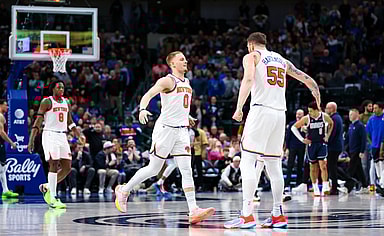 New York Knicks guard Donte DiVincenzo (0) celebrates with New York Knicks center Isaiah Hartenstein (55) after scoring during the second half against the Dallas Mavericks at American Airlines Center