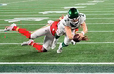 New York Jets quarterback Zach Wilson (2) scores a two point conversion ahead of Kansas City Chiefs linebacker Willie Gay (50) in the second half at MetLife Stadium
