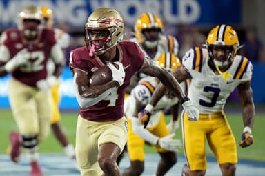 Florida State Seminoles wide receiver Keon Coleman (4) runs the ball for a touchdown during the first half against the Louisiana State Tigers at Camping World Stadium (Giants prospect)