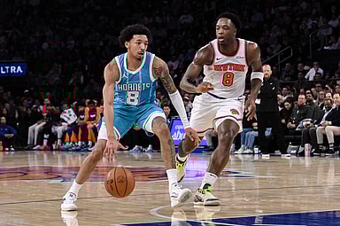 Dec 5, 2024; New York, New York, USA; Charlotte Hornets guard Nick Smith Jr. (8) drives to the basket while being defended by New York Knicks forward OG Anunoby (8) during the first half at Madison Square Garden. Mandatory Credit: John Jones-Imagn Images