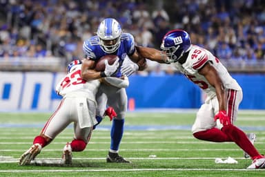 Detroit Lions running back Devine Ozigbo (30) runs against New York Giants linebacker Habakkuk Baldonado (45) and New York Giants safety Alex Cook (23) during the second half of a preseason game at Ford Field in Detroit