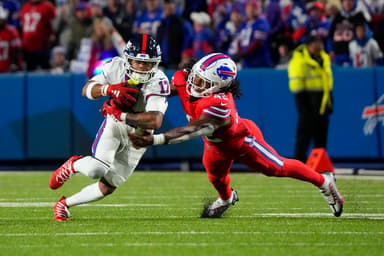 Buffalo Bills linebacker Dorian Williams (42) tackles New York Giants wide receiver Wan'Dale Robinson (17) running with the ball during the second half at Highmark Stadium