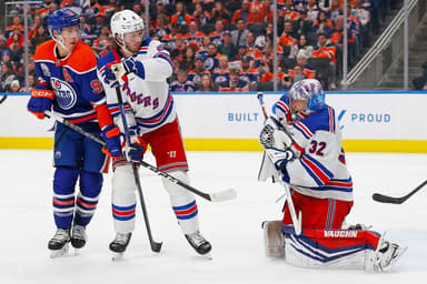 Edmonton Oilers forward Ryan Nugent-Hopkins (93) and New York Rangers defensemen Jacob Trouba (8) battle in front of New York Rangers goaltender Jonathan Quick (32) as he makes a save during the third period at Rogers Place