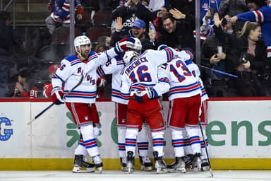 New York Rangers left wing Artemi Panarin (10) celebrates with teammates after scoring a goal against the New Jersey Devils during the third period at Prudential Center