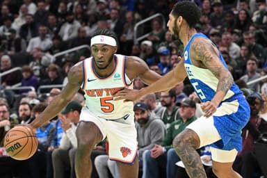 New York Knicks guard Immanuel Quickley (5) drives to the basket against Milwaukee Bucks guard Cameron Payne (15) in the first half at Fiserv Forum