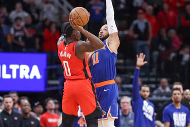 New York Knicks guard Jalen Brunson (11) fouls Houston Rockets guard Aaron Holiday (0) on a play in the final moments of the fourth quarter at Toyota Center