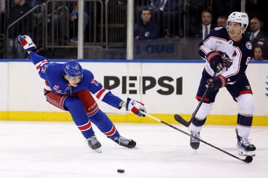 Columbus Blue Jackets defenseman Zach Werenski (8) plays the puck against New York Rangers center Matt Rempe (73) during the second period at Madison Square Garden