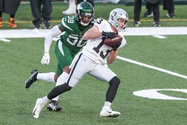 Dec 6, 2020; East Rutherford, New Jersey, USA; Las Vegas Raiders wide receiver Hunter Renfrow (13) catches the ball as New York Jets cornerback Lamar Jackson (38) pursues during the first half at MetLife Stadium. Mandatory Credit: Vincent Carchietta-USA TODAY Sports