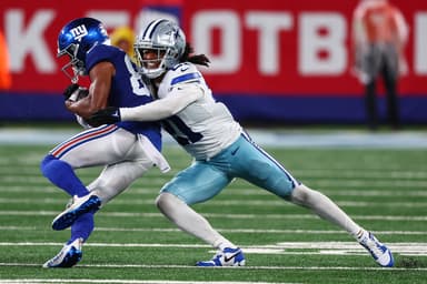 Sep 10, 2023; East Rutherford, New Jersey, USA; Dallas Cowboys cornerback Stephon Gilmore (21) tackles New York Giants wide receiver Darius Slayton (86) during the second half at MetLife Stadium. Mandatory Credit: Ed Mulholland-USA TODAY Sports