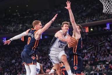 Mar 8, 2024; New York, New York, USA;  Orlando Magic forward Franz Wagner (22) drives in between New York Knicks guard Donte DiVincenzo (0) and center Isaiah Hartenstein (55) in the first quarter at Madison Square Garden. Mandatory Credit: Wendell Cruz-USA TODAY Sports