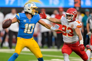 Sep 29, 2024; Inglewood, California, USA;  Los Angeles Chargers quarterback Justin Herbert (10) throws an incomplete pas as is pressured by Kansas City Chiefs linebacker Drue Tranquill (23) at SoFi Stadium. Mandatory Credit: Jayne Kamin-Oncea-Imagn Images