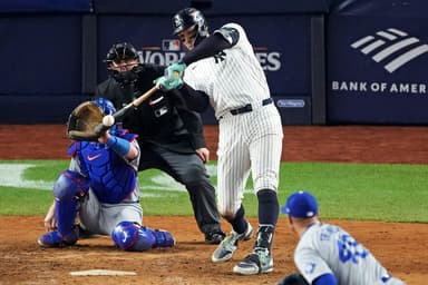 Oct 30, 2024; New York, New York, USA; New York Yankees outfielder Aaron Judge (99) hits a double during the eighth inning against the Los Angeles Dodgers in game four of the 2024 MLB World Series at Yankee Stadium. Mandatory Credit: Robert Deutsch-Imagn Images
