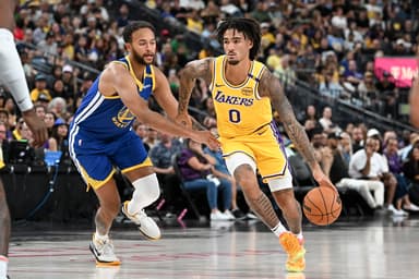 Oct 15, 2024; Las Vegas, Nevada, USA; Los Angeles Lakers guard Jalen Hood-Schifino (0) drives past Golden State Warriors forward Kyle Anderson (1) in the third quarter during a preseason game at T-Mobile Arena. Mandatory Credit: Candice Ward-Imagn Images
