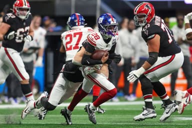 Dec 22, 2024; Atlanta, Georgia, USA; New York Giants cornerback Cor'Dale Flott (28) returns an interception against the Atlanta Falcons in the second quarter at Mercedes-Benz Stadium. Mandatory Credit: Brett Davis-Imagn Images