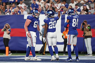 New York Giants running back Eric Gray (20) celebrates his rushing touchdown  with center John Michael Schmitz Jr. (61) and wide receiver Jalin Hyatt (84) during the first half against the Carolina Panthers at MetLife Stadium