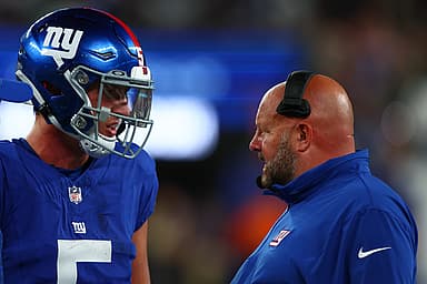 New York Giants head coach Brian Daboll speaks with quarterback Tommy DeVito (5) during the second half of their game against the New York Jets at MetLife Stadium