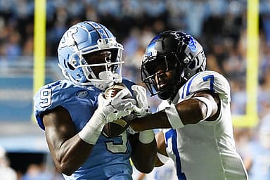 North Carolina Tar Heels wide receiver Devontez Walker (9) (New York Giants prospect) catches the ball as Duke Blue Devils cornerback Al Blades Jr. (7) defends in the first quarter at Kenan Memorial Stadium