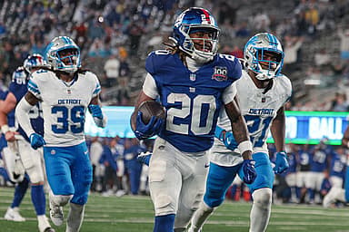 Aug 8, 2024; East Rutherford, New Jersey, USA; New York Giants running back Eric Gray (20) scores a rushing touchdown in front of Detroit Lions cornerback Amik Robertson (21) and cornerback Morice Norris (39) during the first half at MetLife Stadium. Mandatory Credit: Vincent Carchietta-USA TODAY Sports