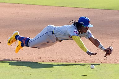 Oct 14, 2024; Los Angeles, California, USA; New York Mets shortstop Luisangel Acuna (2) attempts to field a ground ball against the Los Angeles Dodgers in the eighth inning during game two of the NLCS for the 2024 MLB Playoffs at Dodger Stadium. Mandatory Credit: Jason Parkhurst-Imagn Images