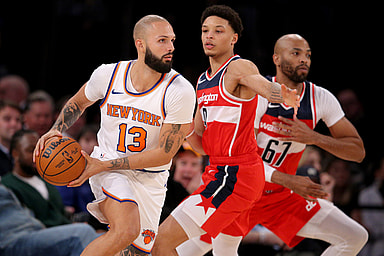 New York Knicks guard Evan Fournier (13) controls the ball against Washington Wizards guard Ryan Rollins (9) and forward Taj Gibson (67) during the fourth quarter at Madison Square Garden