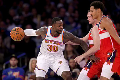 New York Knicks forward Julius Randle (30) controls the ball against Washington Wizards forward Danilo Gallinari (88) and guard Jordan Poole (13) during the third quarter at Madison Square Garden
