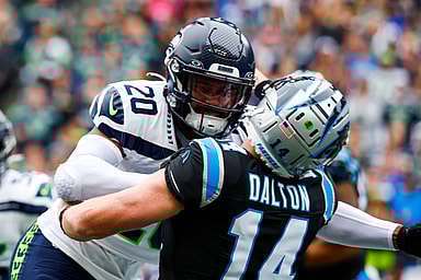 Seattle Seahawks safety Julian Love (20) hits Carolina Panthers quarterback Andy Dalton (14) following a pass attempt by Dalton during the first quarter at Lumen Field, Giants