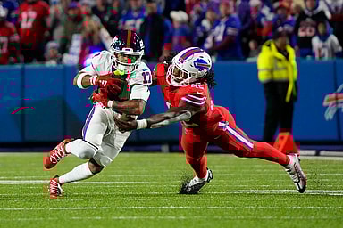 Buffalo Bills linebacker Dorian Williams (42) tackles New York Giants wide receiver Wan'Dale Robinson (17) running with the ball during the second half at Highmark Stadium