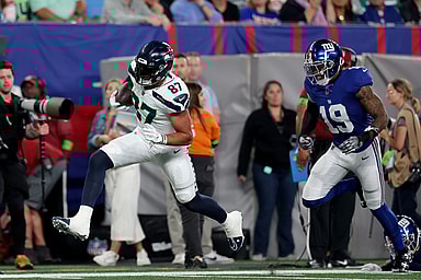 Seattle Seahawks tight end Noah Fant (87) runs with the ball against New York Giants safety Isaiah Simmons (19) during the second quarter at MetLife Stadium