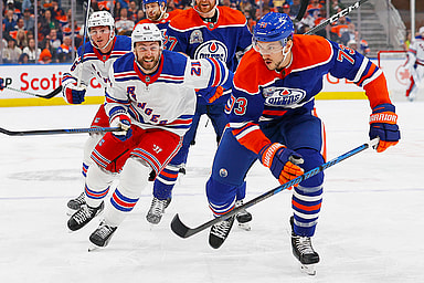 Edmonton Oilers defensemen Vincent Desharnais (73) and New York Rangers forward Barclay Goodrow (21) chase a loos puck during the second period at Rogers Place