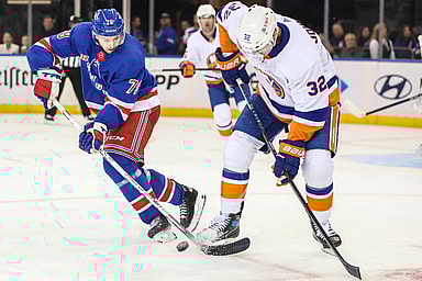 New York Rangers left wing Brennan Othmann (78) and New York Islanders left wing Ross Johnston (32) battle for control of the puck in the third period at Madison Square Garden
