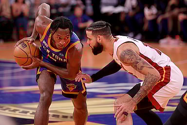 New York Knicks guard Immanuel Quickley (5) controls the ball against Miami Heat forward Caleb Martin (16) during the fourth quarter at Madison Square Garden