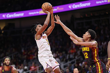 New York Knicks guard Immanuel Quickley (5) shoots over Atlanta Hawks forward De'Andre Hunter (12) in the second quarter at State Farm Arena