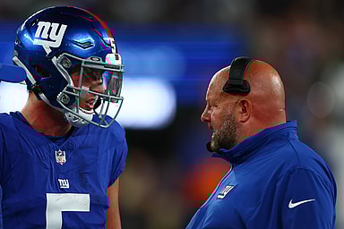 New York Giants head coach Brian Daboll speaks with quarterback Tommy DeVito (5) during the second half of their game against the New York Jets at MetLife Stadium