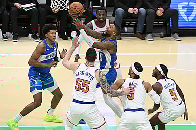 Milwaukee Bucks guard Damian Lillard (0) drives to the basket against New York Knicks defenders in the second half at Fiserv Forum