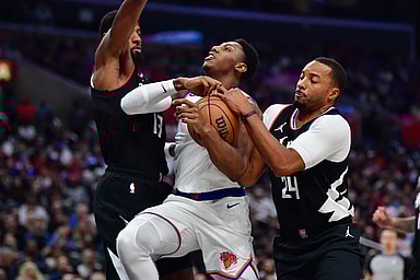 Los Angeles Clippers forward Paul George (13) and guard Norman Powell (24) defend against New York Knicks guard RJ Barrett (9) during the second half at Crypto.com Arena