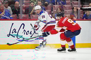 New York Rangers left wing Jimmy Vesey (26) passes the puck away from Florida Panthers defenseman Oliver Ekman-Larsson (91) during the first period at Amerant Bank Arena