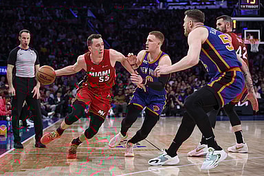 Miami Heat forward Duncan Robinson (55) dribbles against New York Knicks guard Donte DiVincenzo (0) and center Isaiah Hartenstein (55) during the first half at Madison Square Garden