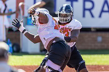 American offensive lineman Christian Haynes of Uconn (63) (New York Giants prospect) faces off against American offensive lineman Christian Jones of Texas (70) during practice for the American team at Hancock Whitney Stadium