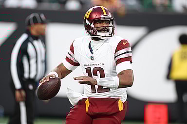 Washington Commanders quarterback Jacoby Brissett (12) throws the ball during the second half against the New York Jets at MetLife Stadium
