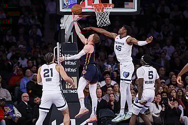 New York Knicks guard Donte DiVincenzo (0) shoots a lay up for a basket during the fourth quarter as Memphis Grizzlies forward GG Jackson (45) defends at Madison Square Garden