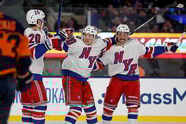 New York Rangers left wing Chris Kreider (20) celebrates his goal against the New York Islanders with left wing Artemi Panarin (10) and center Vincent Trocheck (16) during the third period of a Stadium Series ice hockey game at MetLife Stadium