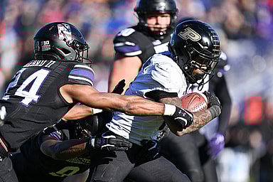 Nov 18, 2023; Evanston, Illinois, USA; Purdue Boilermakers running back Tyrone Tracy Jr. (3)(New York Giants) breaks a tackle by Northwestern Wildcats defensive back Rod Heard II (24) for a touchdown run in the third quarter at Ryan Field. Mandatory Credit: Jamie Sabau-USA TODAY Sports